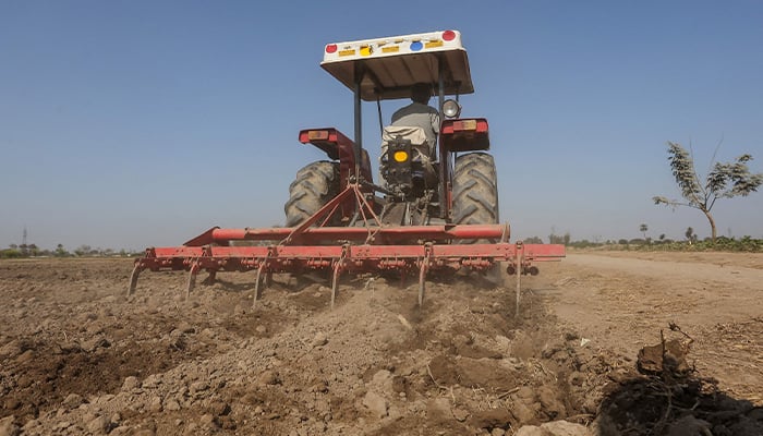 A farmer ploughs a field using a tractor in Multan on January 23, 2025. — AFP