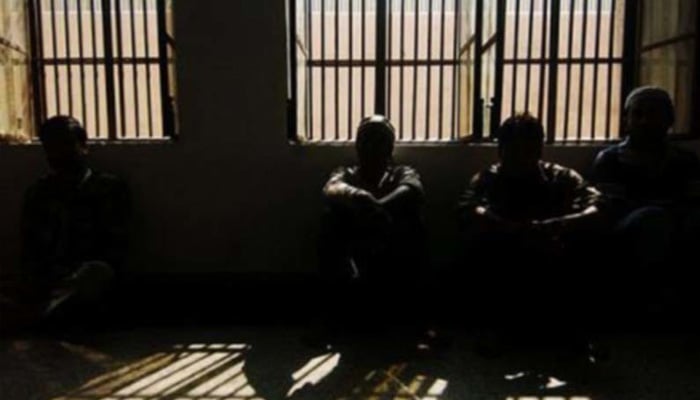 Representational image of prisoners sitting in a prison cell. — AFP/File