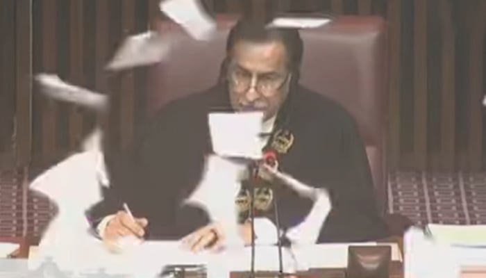 NA Speaker Ayaz Sadiq is seen in this still taken from a video while pieces of paper fly in front of him as opposition lawmakers tear copies of the legislative agenda during joint session on January 24, 2025. — YouTube/PTVParliament