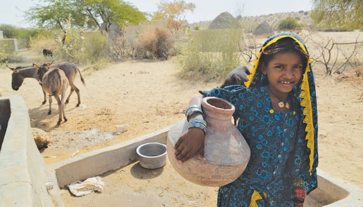 A girl child fetching water in Thar smiles for a photograph. — Photo by TKF via author