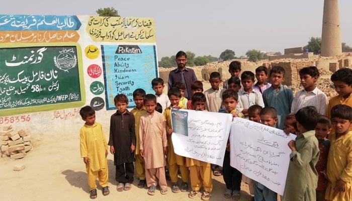 Children hold placards during a dengue awareness campaign at a non-formal school. — Literacy.punjab.gov.pk