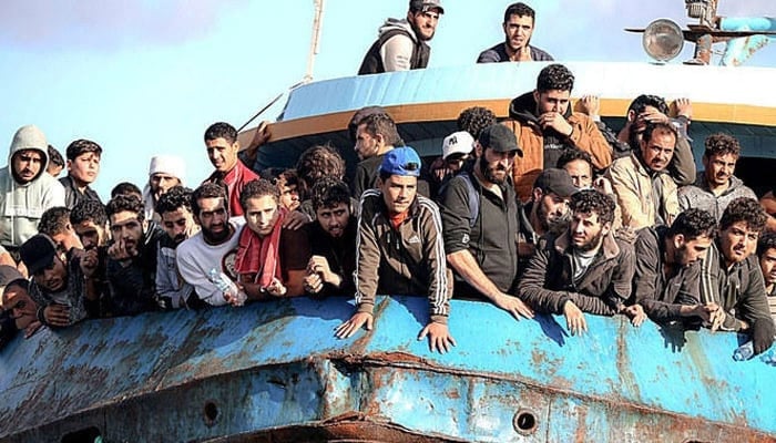 Migrants loaded on the deck of a boat travelling by sea from their respective countries. — AFP/File