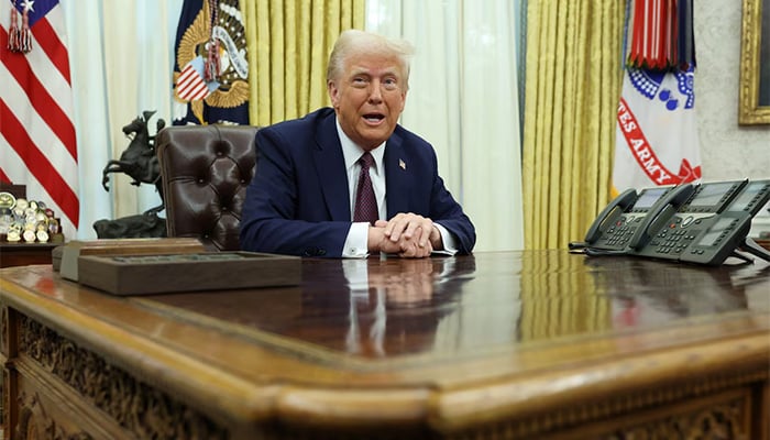 US President Donald Trump sits in the Oval Office of the White House, as he signs executive orders, in Washington, US, January 23, 2025. — Reuters