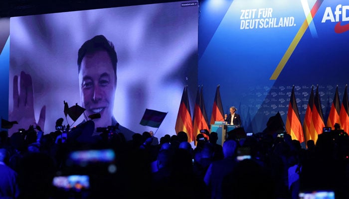 US tech billionaire and businessman Elon Musk (L) is seen on a large screen as Alice Weidel, co-leader of Germany’s far-right Alternative for Germany (AfD) party, addresses an election campaign rally in Halle, eastern Germany on January 25, 2025. — AFP