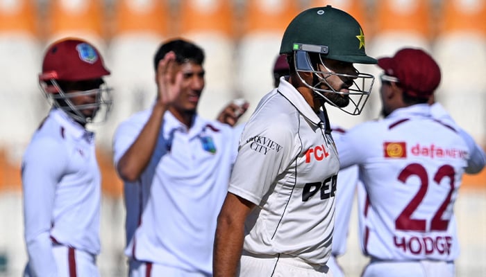 West Indies´ players celebrate as Pakistan´s Babar Azam walks back to the pavilion after his dismissal during the first day of the second Test cricket match between Pakistan and West Indies at the Multan Cricket Stadium in Multan on January 25, 2025. — AFP