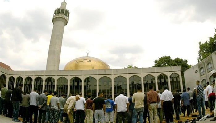 Muslim stand in line to pray at a mosque in the UK. — AFP/File