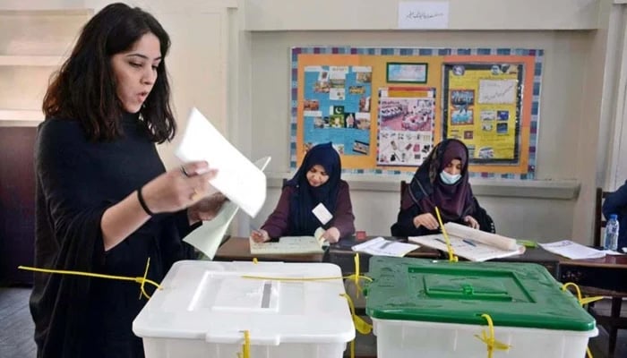 A female voter is casting her vote at a polling station in Karachi during the general elections on February 8, 2024. — APP