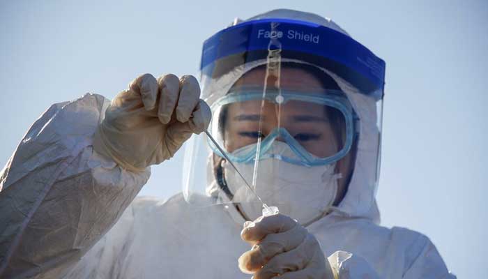 A member of the medical personnel works at a coronavirus disease (COVID-19) testing site which is temporarily set up at a railway station in Seoul, South Korea, December 15, 2020. — Reuters