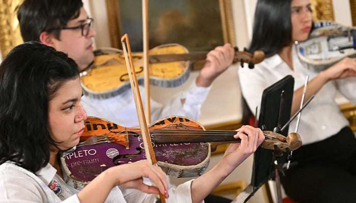 Members of the Paraguayan Recycled Orchestra of Cateura take part in a rehearsal ahead of a performance for an audience inside Lancaster House in London on January 26, 2025. — AFP