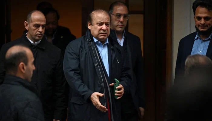 PML-N President and former premier Nawaz Sharif (c) leaves a property in west London. — AFP/File