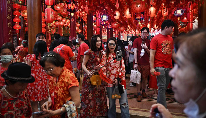 People gather at a shrine on the first day of the Lunar New Year of the Snake in Bangkok on January 29, 2025. — AFP