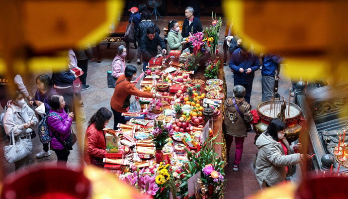 People offer prayers on the first day of the Lunar New Year of the Snake at a temple in Keelung on January 29, 2025. — AFP