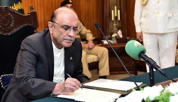 President Asif Ali Zardari signing a bill at the President House in Islamabad, July 23, 2024. — PID