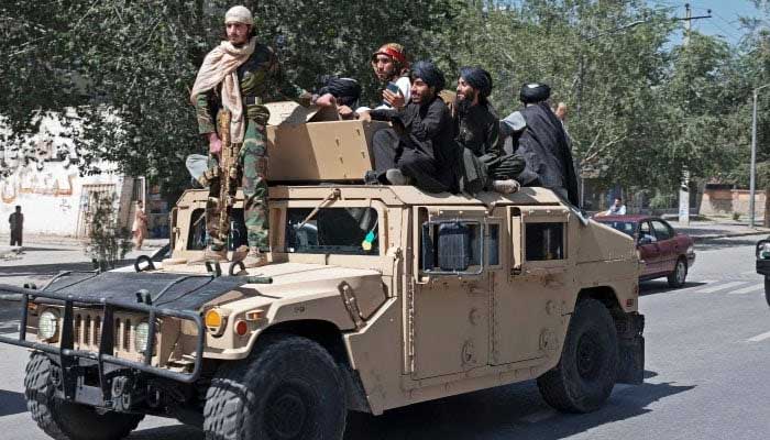 Taliban fighters parade atop vehicles as they celebrate the first anniversary of the withdrawal of US-led troops from Afghanistan in Kabul. — AFP/File