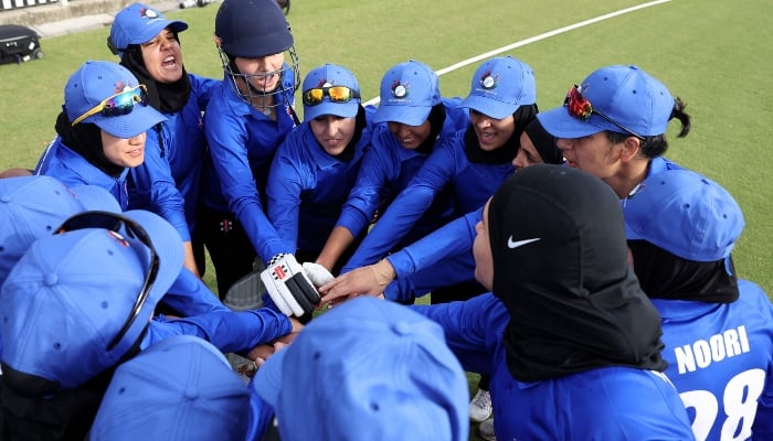 Afghanistan Womens XI players huddle before the cricket match between Afghanistan Womens XI and Cricket Without Borders XI at Junction Oval in Melbourne on January 30, 2025. — AFP