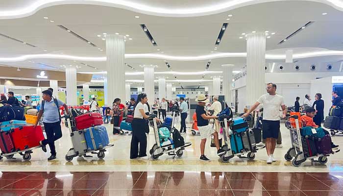 People queue at the check-in counter at the Dubai International Airport, in Dubai, United Arab Emirates, April 17, 2024. — Reuters