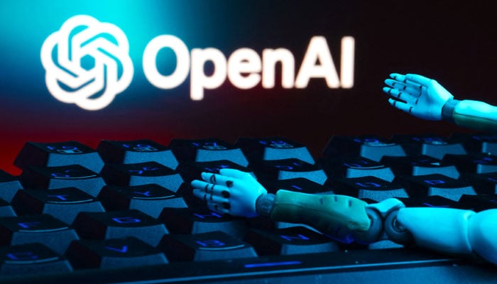 The OpenAI logo, a keyboard, and robot hands are seen in this illustration taken January 27, 2025. — Reuters