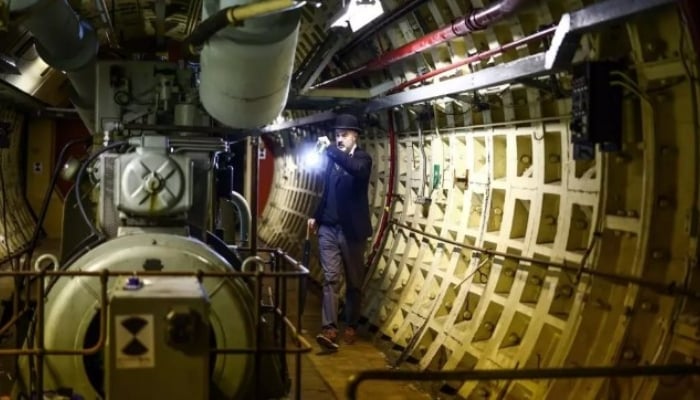 A worker is inspecting the machinery in The London Tunnels in London. — AFP/ File