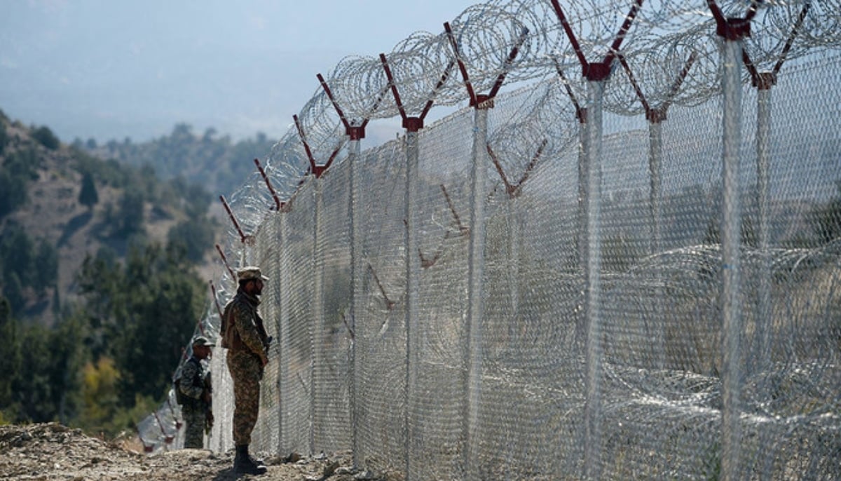 In this file photo, Pakistani soldiers keep vigil next to newly fenced border fencing along with Afghans Paktika province border in Angoor Adda in Pakistans South Waziristan tribal agency on Oct. 18, 2017. — AFP