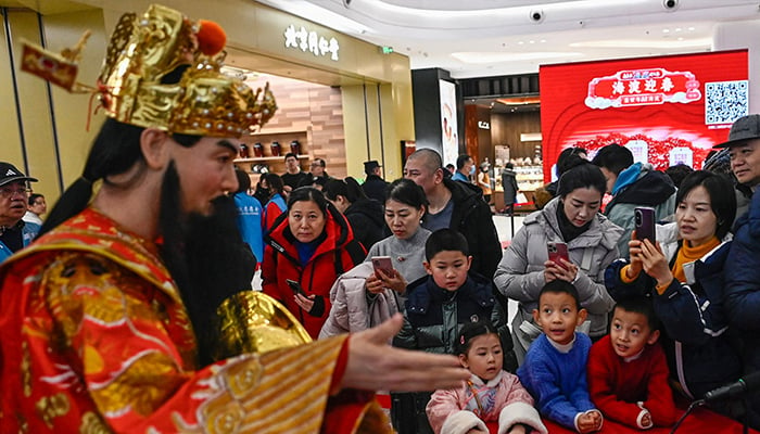 A humanoid robot wearing a traditional Chinese costume is seen during the Spring Festival Science and Technology Temple Fair in Beijing on January 31, 2025. — AFP