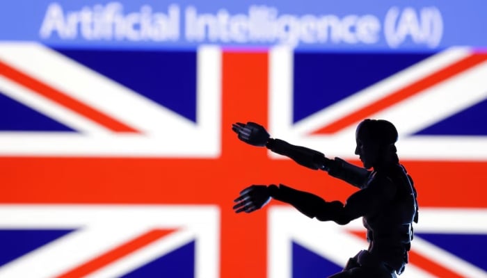 Artificial Intelligence (AI) words, miniature of robot and British flag are seen in this illustration taken on December 21, 2023. — Reuters