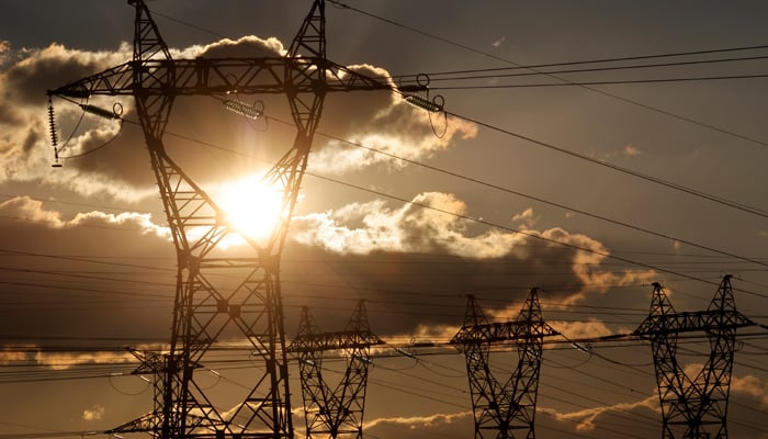 Electrical power pylons of high-tension electricity power lines are seen close to the EDF Bouchain power plant in Mastaing, France, March 19, 2021. — Reuters