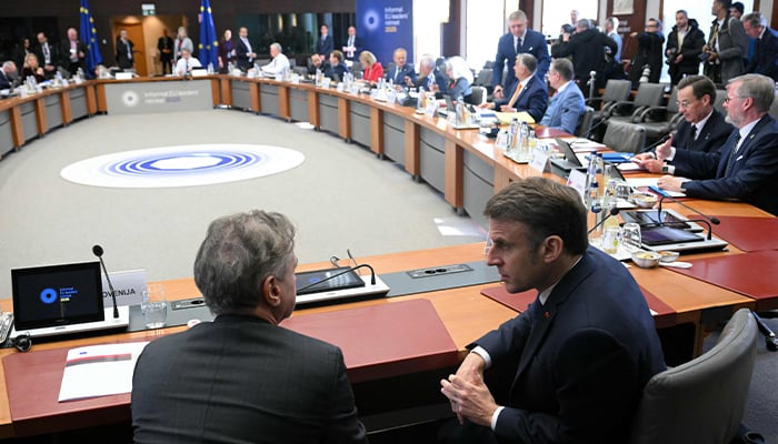 Frances President Emmanuel Macron (R) speaks with Slovenias Prime Minister Robert Golob prior to the start of the round-table meeting at the informal EU leaders retreat at the Palais degmont in Brussels on February 3, 2025. — AFP