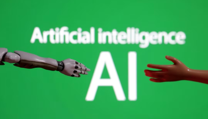 Words reading Artificial intelligence AI, miniature of robot and toy hand are pictured in this illustration taken on December 14, 2023. — Reuters