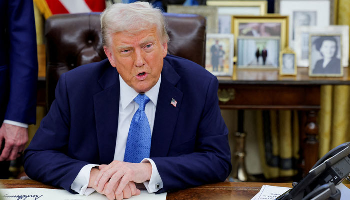 US President Donald Trump looks on as he signs an executive order in the Oval Office at the White House in Washington, US, January 31, 2025. — Reuters