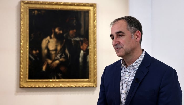 Director of the Andreas Pittas Art Characterisation Laboratories (APAC) of the Cyprus Institute Nikolaos Bakirtzis stands next to the Ecce Homo painting, produced by Titian, at the Limassol Municipal Arts Center in Limassol, Cyprus, on January 30, 2025. — Reuters