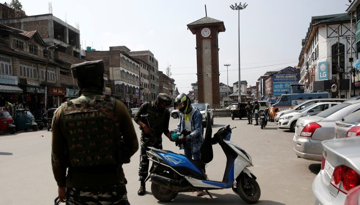 Indian Central Reserve Police Force (CRPF) personnel check the bags of a scooterist as part of security checking in Srinagar, October 12, 2021. — Reuters