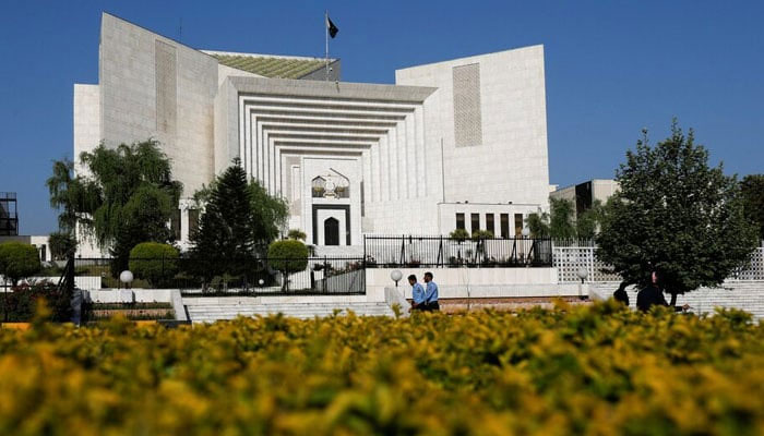 Police officers walk past the Supreme Court  building, in Islamabad on April 6, 2022. — Reuters