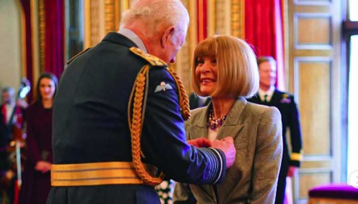 Dame Anna Wintour takes off sunglasses to receive honour from King Charles