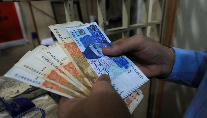 A man has Pakistani rupees tickets in a exchange shop in Peshawar, September 12, 2023. - Reuters