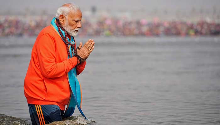 This handout photograph taken on February 5, 2025 and released by the Indian Press Information Bureau (PIB) shows India´s Prime Minister Narendra Modi offering prayers before taking a holy dip in the sacred waters of Sangam. — AFP