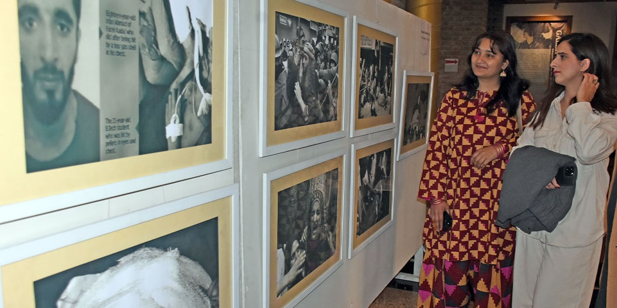 Women are interested in the photographs of the Kashmir oppressed during the exhibition on the eve of Solidarity Cashmere Day in Pakistan National Council of Arts in Islamabad on February 5, 2025. - Online