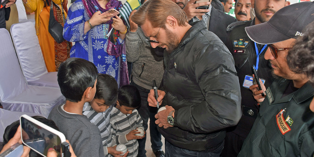 Shahid Khan Afridi signing autographs for children after Kashmir Day Exhibition match, in Muzaffarabad, Azad Jammu and Kashmir on February 5, 2025. — Online