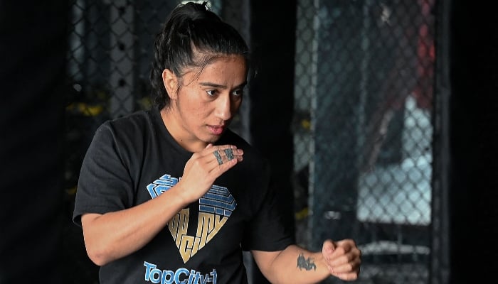 In this photograph taken on December 11, 2024, Anita Karim, a mixed martial arts  fighter, takes part in a training session at a club in Islamabad. — AFP