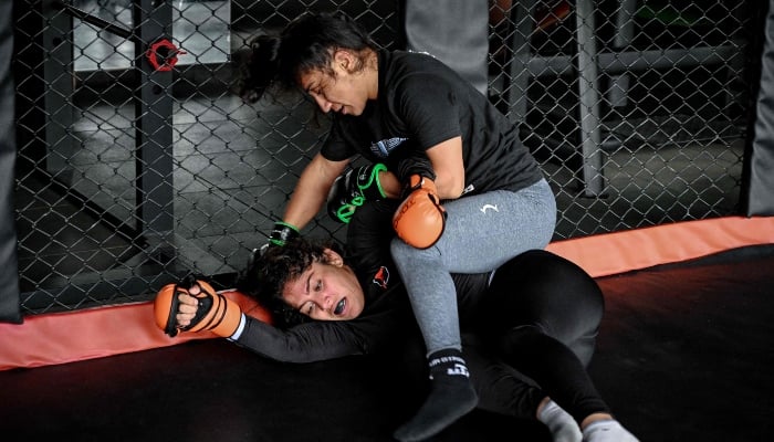 In this photograph taken on December 11, 2024, Anita Karim and Bushra Ahmed, take part in a training session at a club in Islamabad. — AFP