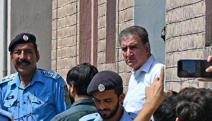 PTI senior leader Shah Mahmood Qureshi is seen outside a special court after he was granted a four-day physical remand in Islamabad. — AFP/File