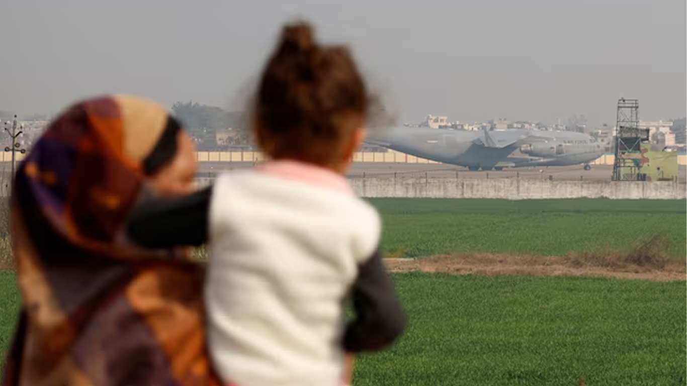 People look at a U.S. military plane deporting Indian immigrants as it lands in Amritsar, India February 5, 2025. — Reuters