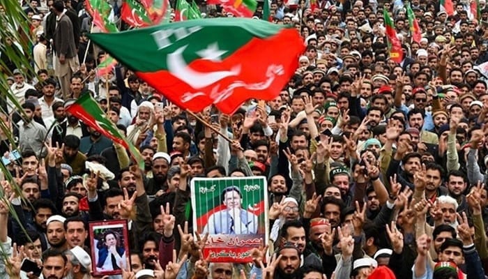 PTI supporters hold portraits of party founder Imran Khan during a rally in Peshawar. — AFP/File