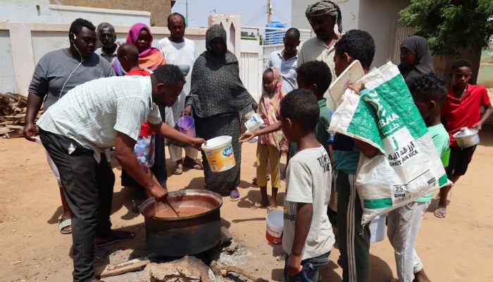 A volunteer stirs food to be distributed to people in Omdurman, Sudan, on September 3, 2023. —Reuters