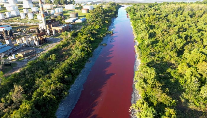 This aerial view shows an unusual reddish color of the Sarandi Canal seeping into the Rio de la Plata River in Sarandi, Avellaneda in the outskirts of Buenos Aires on February 6, 2025. — AFP