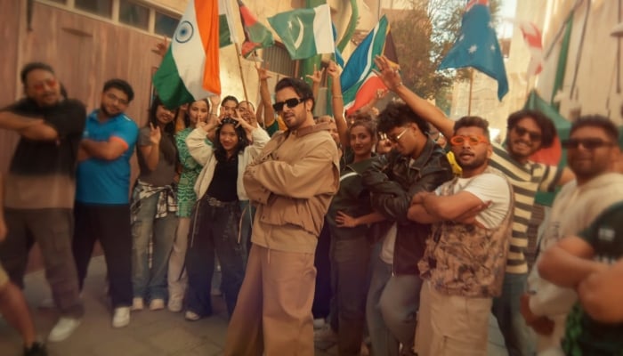 Singer Atif Aslam (centre) poses during shooting of the ICC Champions Trophy 2025 songs video. — YouTube/ @ICC/ File