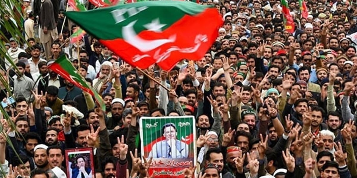 PTI supporters hold portraits of party founder Imran Khan during a rally in Peshawar. — AFP/File