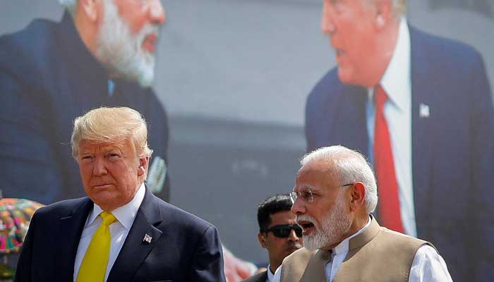 US President Donald Trump (left) and Indian Prime Minister Narendra Modi speak during the welcoming ceremony, as Trump arrives at Sardar Vallabhbhai Patel International Airport in Ahmedabad, India February 24, 2020. — Reuters