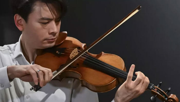 Classical US violinist Stefan Jackiw plays the Joachim-Ma Stradivarius violin during a preview of the violins auction at Sothebys in New York City on February 3, 2025. — AFP