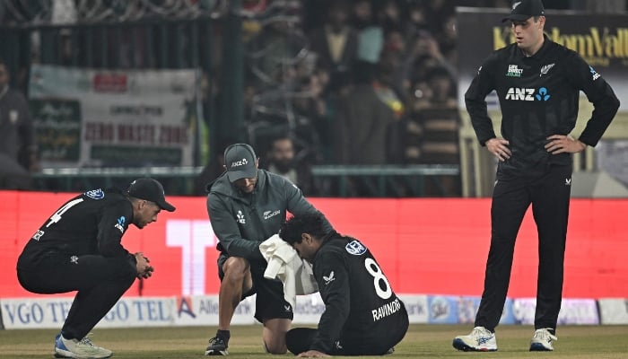 New Zealands Rachin Ravindra (centre) receives medical attention after being hit on the head by the ball during the tri-nation series first ODI match between Pakistan and New Zealand at the Gaddafi Stadium in Lahore on February 8, 2025. — AFP