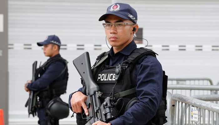 Singaporean policemen stand guard at a media center for the summit between the U.S and North Korea, in Singapore, June 10, 2018. — Reuters